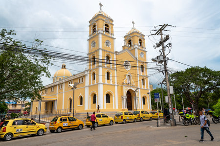 Facade of the Cathedral of San Francisco de AsÃ­s in the city of Sincelejo, with taxis parked in...