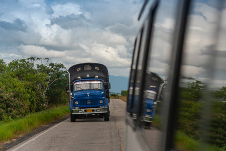 Old truck trying to pass a bus on a rural highway, Casanare, Colombia. December 1, 2020.のeditorial素材