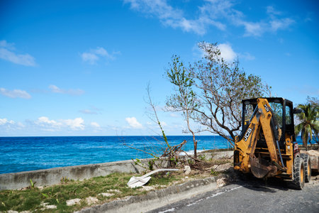 Small excavator to organize debris on a road by the sea. Island of San Andres. Colombia. December...
