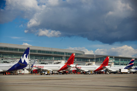 Airplanes of different airlines parked in front of the El Dorado airport building in the city of Bogota. Colombia December 13, 2020.のeditorial素材