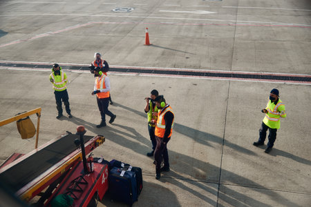 Baggage workers at the El Dorado airport check luggage to put it on the plane. BogotÃ¡ Colombia December 13, 2020.のeditorial素材