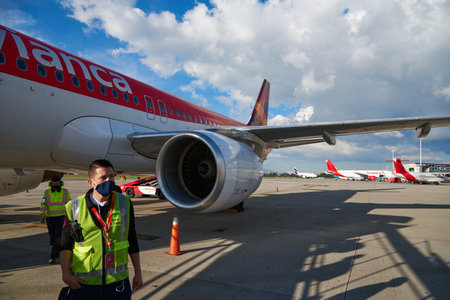 El Dorado airport worker with an Avianca airline in the background. Bogota. Colombia. December 13, 2020.のeditorial素材