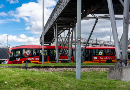 Public transport bus that passes by a stop station with a bridge in the Colombian capital. Bogota Colombia. July 30, 2021のeditorial素材