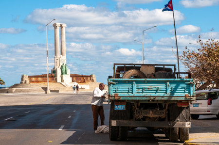 Man repairing an old truck on a street in Old Havana. HAbana. Cuba January 29, 2011.のeditorial素材