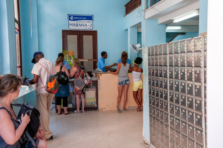Cuban national mail workers serving clients in an office in Old Havana. Havana. Cuba. May 11, 2015.のeditorial素材