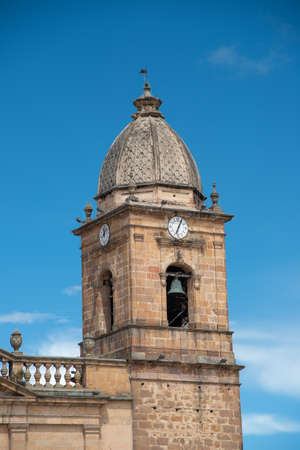 Bell tower with clock of the church in the main square of the city of Tunja. Colombia.の写真素材