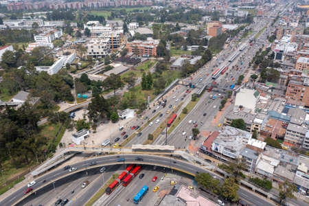 Aerial view of a city with a highway and many buildings.