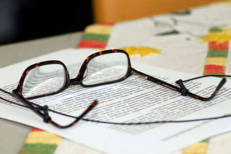 reading glasses lying on paper
