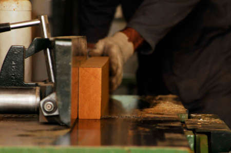 carpenter planing a piece of wood