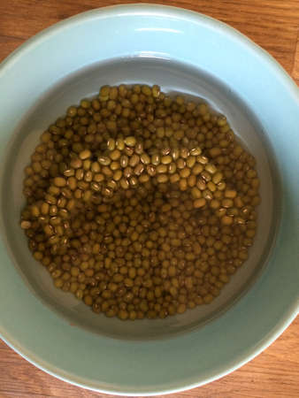 brown lentils soaking in water in a bowl