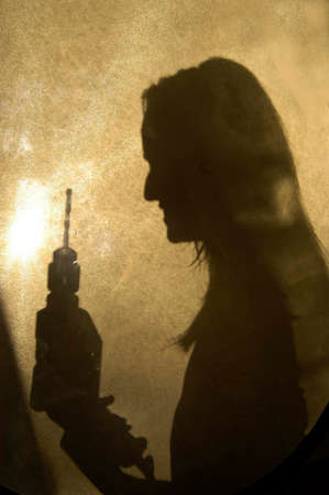 silhouette of a craftswoman holding a drill