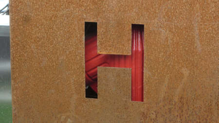 The letter 'H' on a rusty materialの写真素材
