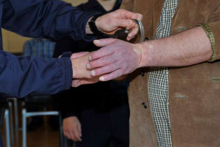 a suspected criminal with handcuffs