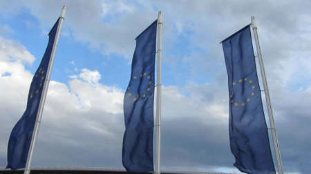 EU flags, cloudy sky in the background 