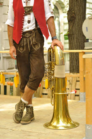 Man in leather trousers with tubaの写真素材