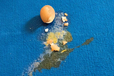 broken egg shell on the floorの写真素材