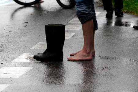 person with rubber boots in flood area
