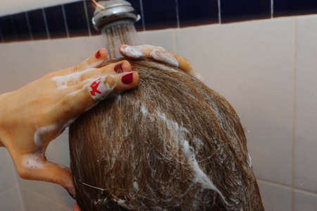 attractive woman washing her hairの写真素材