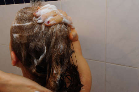 attractive woman washing her hairの写真素材