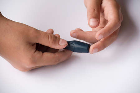 blood sugar level measurement with a blood glucose meterの写真素材