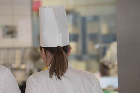 female chef or cook in gastronomy kitchenの写真素材