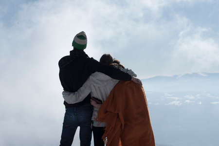 three friends being together on a mountainの写真素材