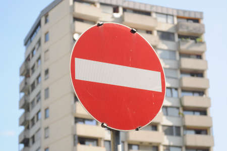 housing market symbolized with no entry sign in front of tower block
