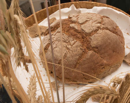 freshly baked brown bread in bread basketの写真素材