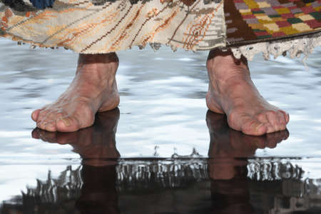 barefoot on a reflecting floorの写真素材