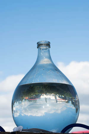 big round water bootle and blue skyの写真素材