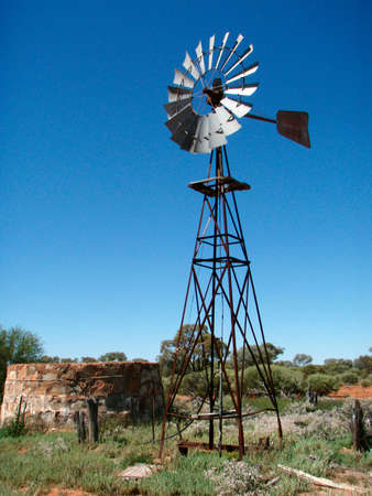 Wind mill next to well in Australiaの写真素材