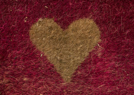 yellow Heart symbol on a red rugの写真素材