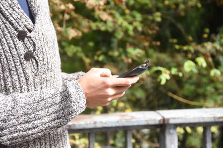 Person using a smartphone, touching the screen with his fingers