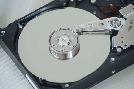 opened hard disk drive, a digital storage medium with mechanical components