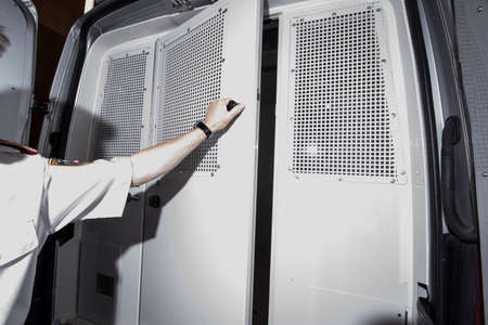 the inside of a prisoner transport car, white bench and floorの写真素材