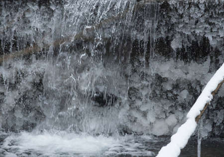 frozen water at a small waterfall in the woods, ice crystals の写真素材