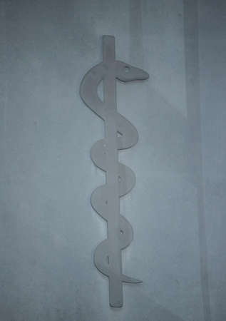 the rod of Aesculapius as the symbol of human medicineの写真素材