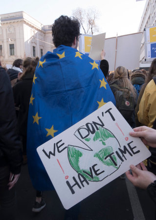 EU citizen wearing a blue EU flag with yellow stars as a capeのeditorial素材