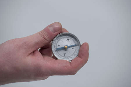 holding a compass in the hand, needle pointing to the north eastの写真素材