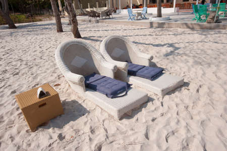 deckchair with pillow on a sandy beach in summer vacationの写真素材