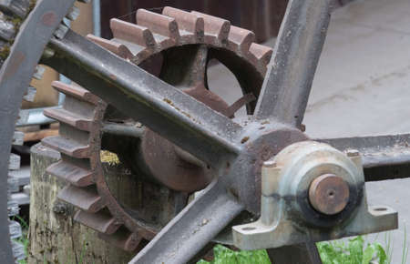 a gear or cog wheel made of metal, part of a machine