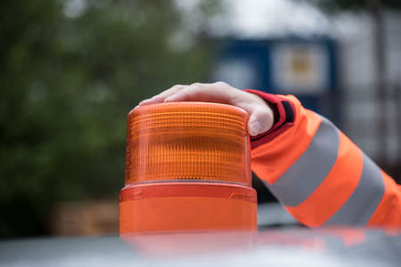 orange flashing light on a car roof, turned off, during daytime