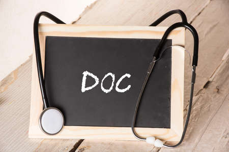 small blackboard that says DOC with a stethoscope around itの写真素材