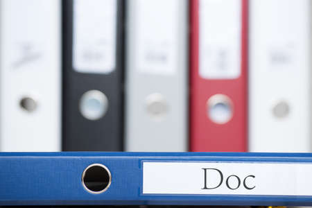blue folder with a DOC sign, more folders standing in the back