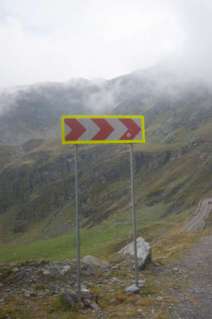 Direction sign with arrow showing the way in road traffic