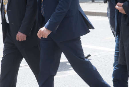 man in suit walking on the street, dynamics in business
