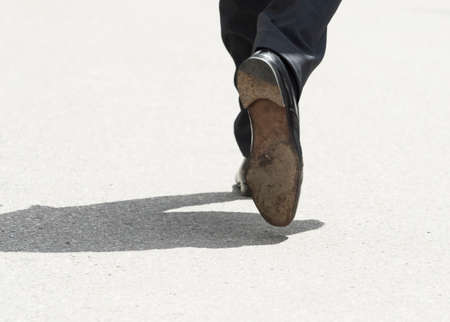 man in suit walking on the street, dynamics in businessの写真素材