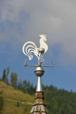 Weathercock on the roof of a building for wind measurementの写真素材