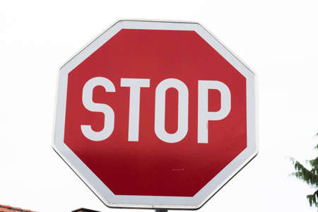 red stop sign in traffic, signaling the driver to completely stop