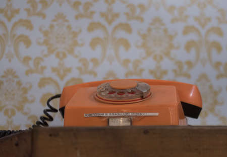 a vintage landline telephone for calling, retro phone set on a tableの写真素材